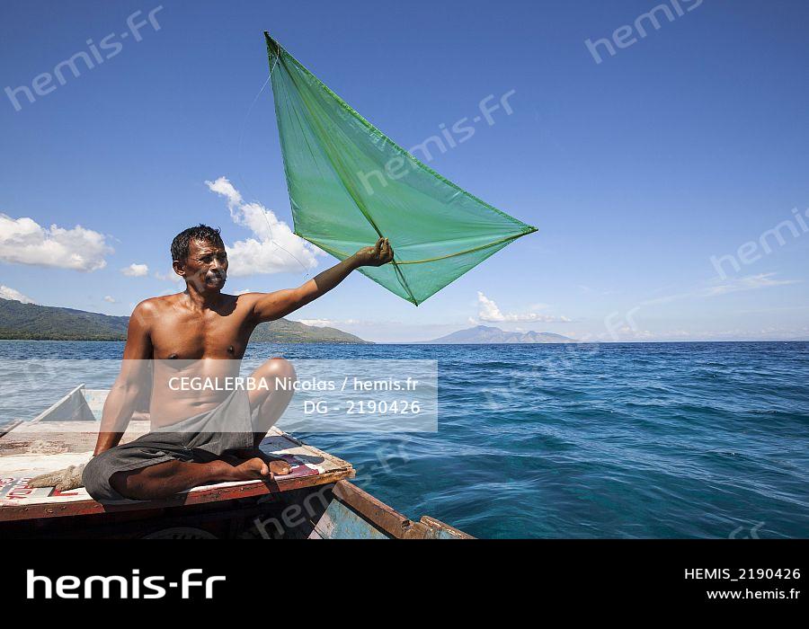 Local fishermen standing in the sea, holding a fishing rod to catch fish,  Lombok Island, Lesser Sunda Islands, Indonesia, Asia Stock Photo - Alamy